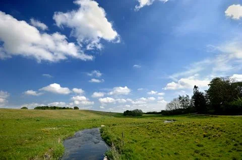 River and cloudy sky Stock Photos