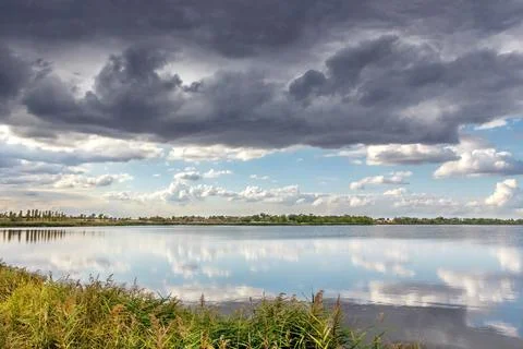 A river and the dramatic cloudscape after the rain. weather change 写真素材