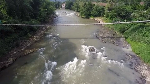 A River and a Hanging Bridge, Sumatra, Camera Approaching Stock Footage 75657443