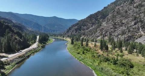 A River and Highway in the Mountains Drone Aerial View Paradise Montana USA 스톡 동영상 335706256