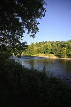 River and a park at sunset Stock Photos