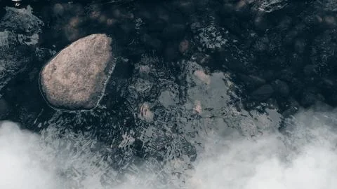 River and rocks background in dark tone. Stock Photos