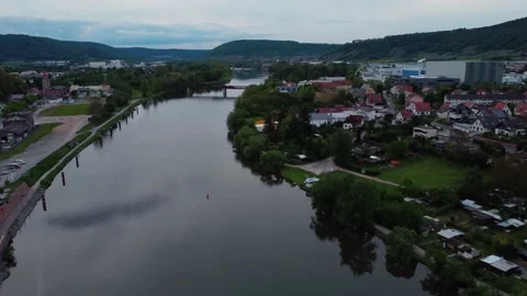 A river and a train bridge next to a town from above Stock Footage 154487004