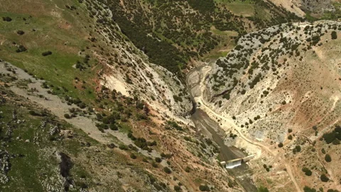 A river and waterfall flowing between two mountains Stock Footage 258262948