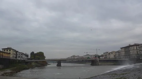 River Arno with Partial Waterfall, Bridge, Urban Landscape Stock Footage 310006543