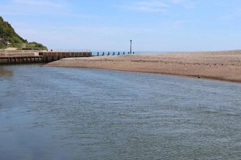 The river Axe flows quickly as it travels towards the sea 스톡 사진