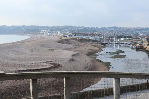 The river Axe near Seaton in Devon curves round a sandbank just before enteri Stock Photos