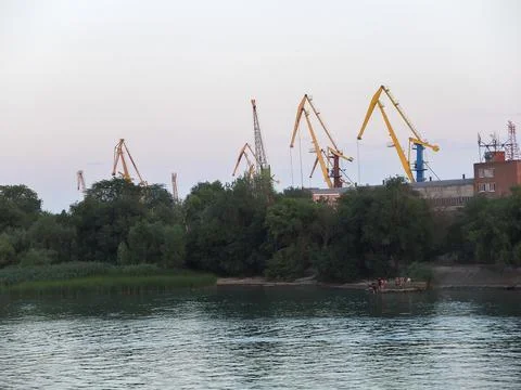 River in the background, cranes for loading, port Stock Photos