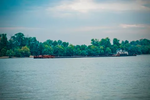 The river barge is moving along the river bed. Coastal landscape. Фото