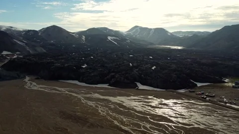 River-bed and a campsite in front of a huge black magma field in rainbow Video stock 165189744