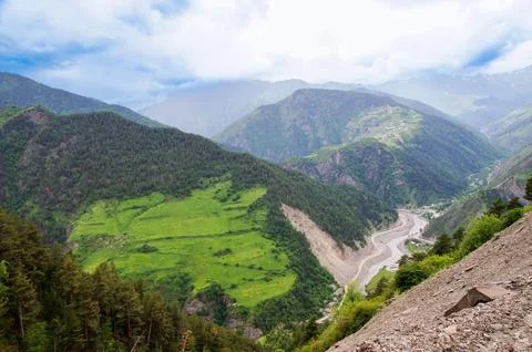 The river bed between the mountains. Stock Photos
