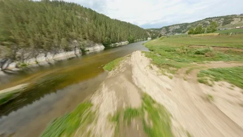 The river bed is close-up. Calm water. The mountains are overgrown with Stock Footage 156388859
