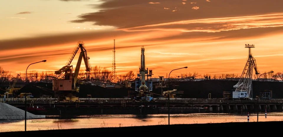 The river bed in the coal unloading zone at the thermal power plant, sunset. Stock Photos
