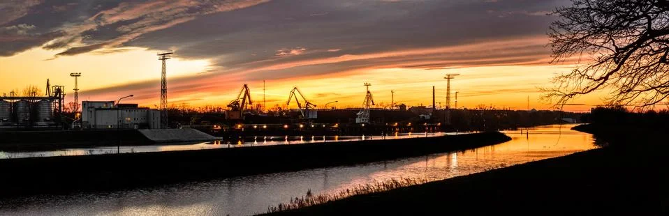 The river bed in the coal unloading zone at the thermal power plant, sunset. Stock Photos