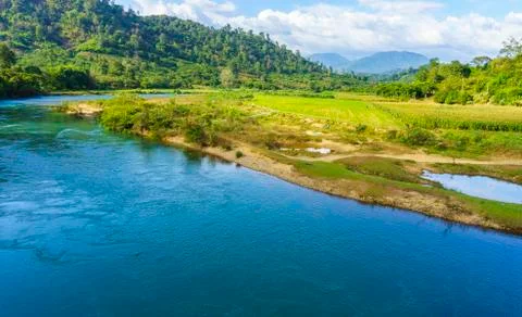 River behind the green field Stock Photos