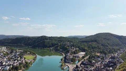 A river bend lies between riverside settlements and wooded hills 動画素材 342336692
