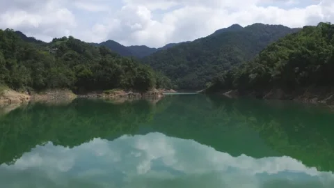 River Beneath Mountain Range – Drone Footage of Natural Landscape Stock Footage 310612860