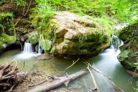 River beside a large boulder Stock Photos