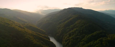 River Between Forested Hills at Dusk Stock Footage 312275372