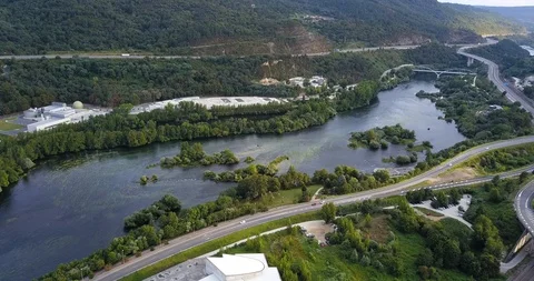 A RIVER BETWEEN ROAD AND FACTORY Stock Footage 92576133