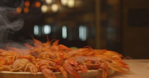 River boiled crayfish .Waiter puts on the table a plate of boiled red crawfish Stock Footage 120854603