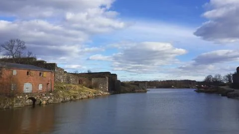 River with a brick building on the bank Stock Photos