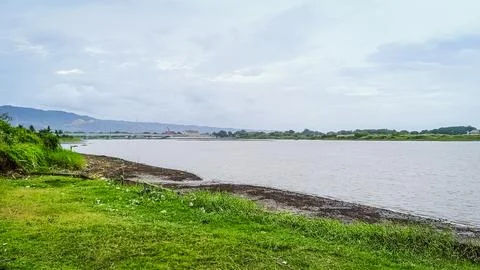 A river with a bridge in the background Stock Photos