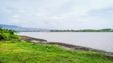 A river with a bridge in the background Stock Photos
