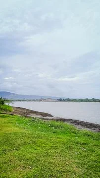 A river with a bridge in the background Stock Photos
