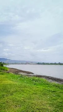 A river with a bridge in the background Stock Photos