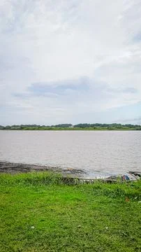 A river with a bridge in the background Stock Photos