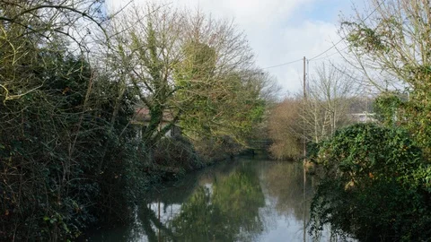 A river with a bridge in nature time lapse in palaiseau near paris france Stock Footage 122524940