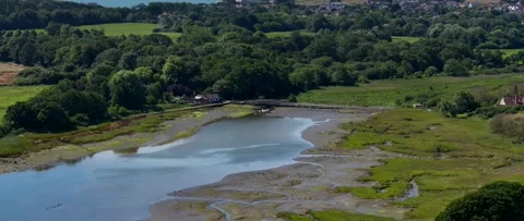 A river with a bridge over it and a house in the background Video stock 298269812
