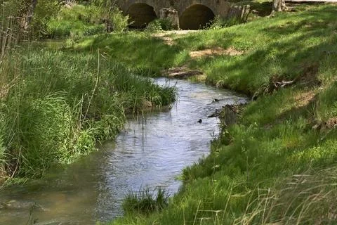 A river with a bridge over it Stock Photos