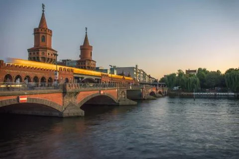 River bridge with yellow train in the sunset Stock Photos