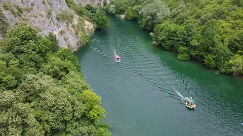River canyon between mountains, drone view. A tourist boat sails on the river. Stock Footage 313730508