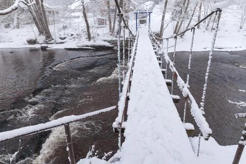 River cascade and a small bridge in the winter. Snowy weather. Joaveski, Esto Stock Photos