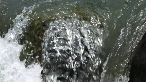 River cascade with clear, fast flowing water between large rocks Stock Footage 292663890
