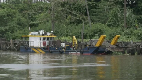 River cleaning boat parked on unfunctional old port of Banjarmasin Stock Footage 142122871