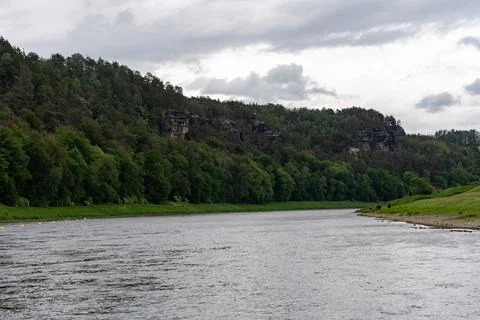 A river with a cloudy sky in the background Stock Photos