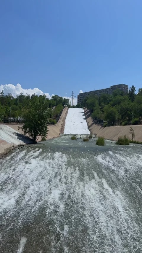 River in concrete channel, water flows. Big Almaty river near Sairan reservoir Stock Footage 325516870