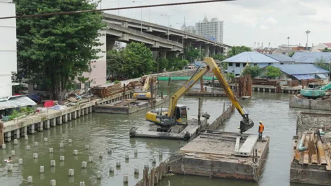 River construction site timelapse with elevated highway backdrop Stock Footage 345861091