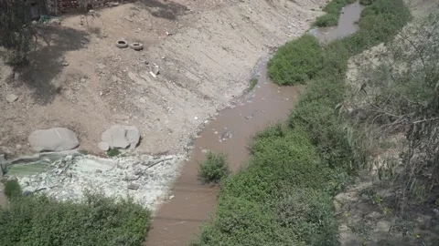 River contamination next to a poor house in Lima Peru pollution Stock Footage 162087715