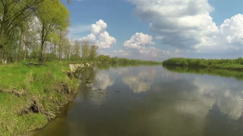 River cost, sun and clouds, reflections in water. Aerial Stock Footage 38002386