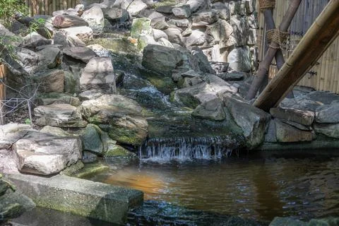River course littered with rocks with waterfall Stock Photos