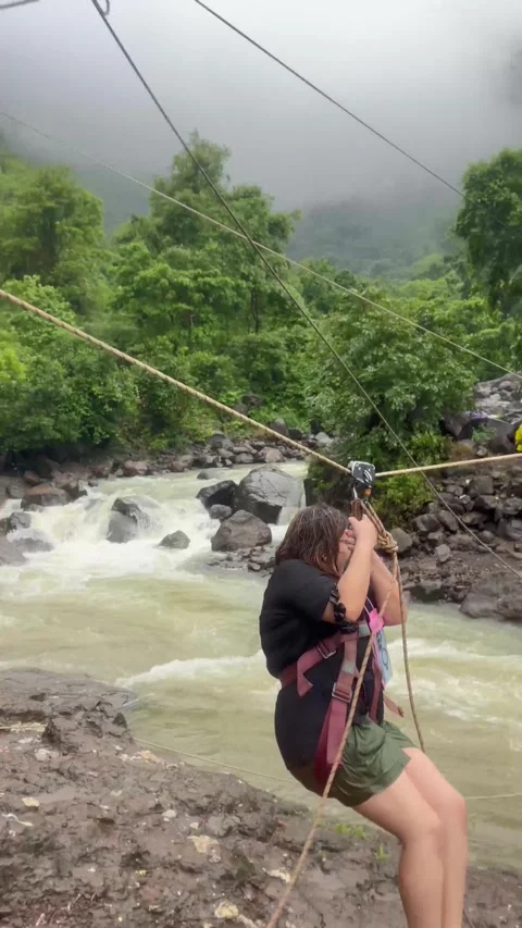 River Crossing Using Zipline Over High Water Flow Vertical Video 4K Stock Footage 346435385