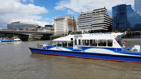 River cruise boats float down the Thames River in London, 4K Stock Footage 110365113