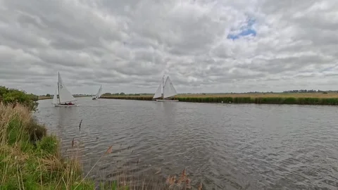 River Cruiser sracing down the River Bure during the 2025 Acle Regatta Stock-Footage 309832763