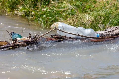 River currents carry plastic bottles and debris Stock Photos