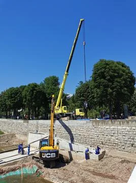 River dam under construction with a large crane Stock Photos